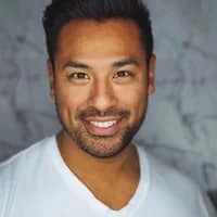 dark man smiling at the camera